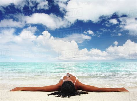 Hawaii Woman Laying On The Beach In Remote Tropical Location Stock Photo Dissolve