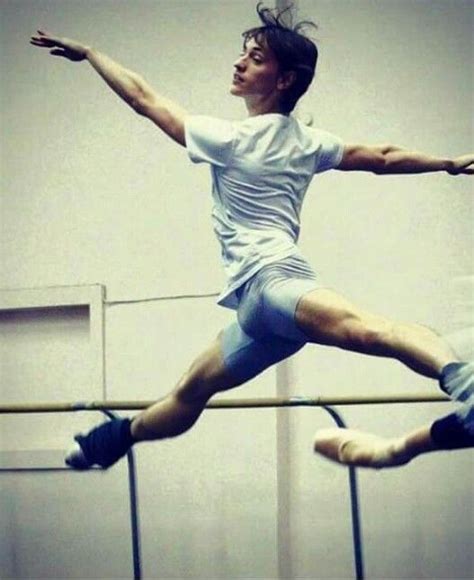 A Man In White Shirt And Shorts Jumping On A Beam