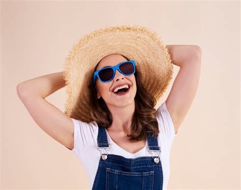Free Photo Portrait Of Joyful Woman With Sunglasses And Sun Hat