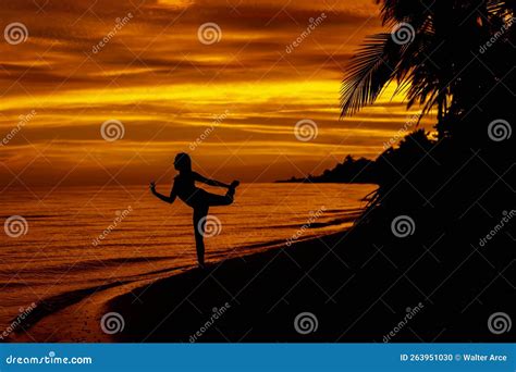 A Nude Latin Model Poses Against The Colorful Sky As The Sun Rises On
