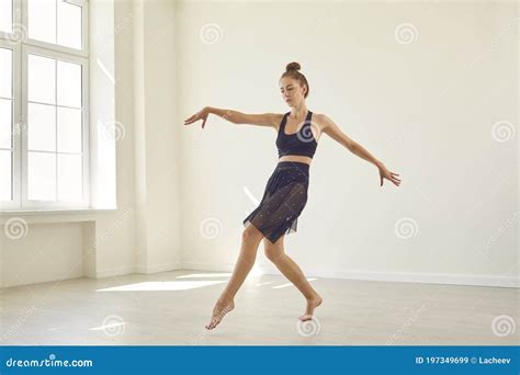 Serious Concentrated Young Female Dancer Practicing Alone In New Modern