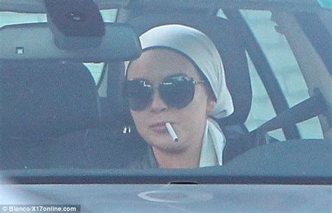 Lindsay Lohan Covers Her Famous Locks With A Headscarf As A Cigarette