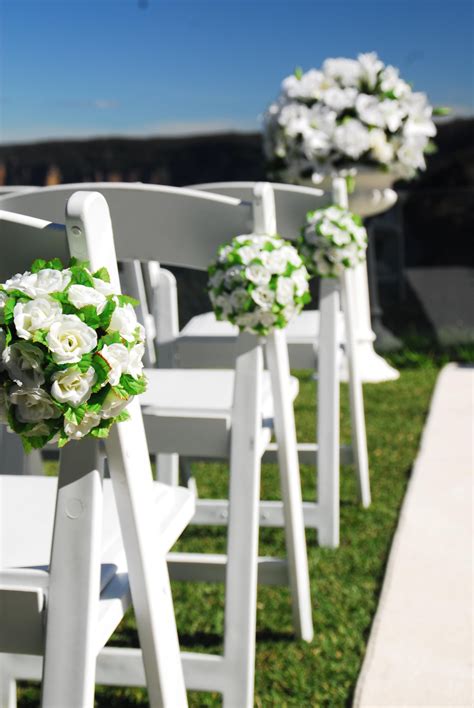 No doubt, you may have consulted with family and close friends. Ailse chairs decorated with white silk flower balls. # ...