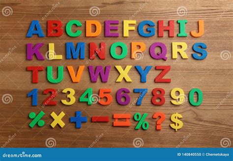 Plastic Magnetic Letters Numbers And Math Symbols On Wooden Background