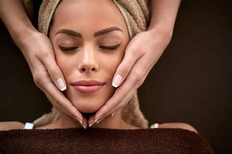 Woman Enjoying During Facial Massage In Cosmetic Salon Stock Image