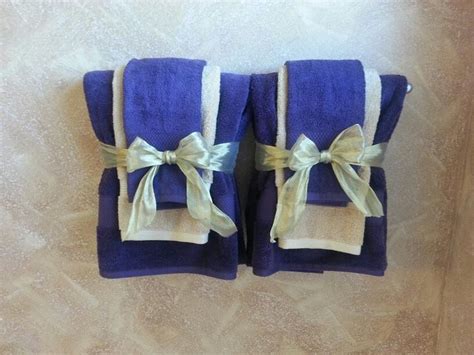 With loop for hanging for easy storage when not in use. Decorative bathroom towels in purple and gold theme ...