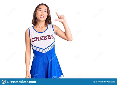 Young Beautiful Chinese Girl Wearing Cheerleader Uniform Smiling And