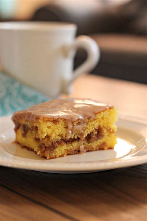 A rich layer of brown sugar, cinnamon and pecans bakes in a golden yellow cake. Honey Bun Cake - Mom Needs Chocolate