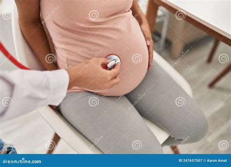 Young Latin Woman Pregnant And Doctor Auscultating Belly At Clinic Stock Image Image Of