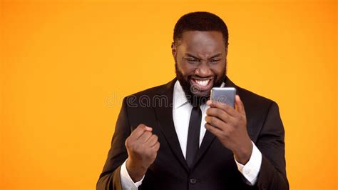 Extremely Happy African American Man Holding Phone And Making Yes