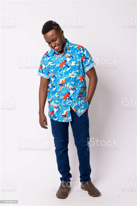 Full Body Shot Of Happy Young African Tourist Man Looking Down Stock