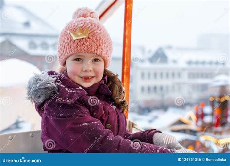 Little Cute Kid Girl Having Fun On Ferris Wheel On Traditional German