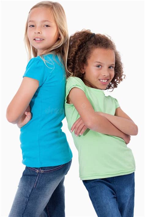 Portrait Of Happy Girls Standing Back To Back Stock Photo Image Of