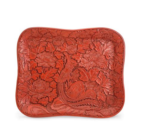 The inscribed labels, noted made in. A cinnabar lacquer tray, (2), of shaped rectangular form ...