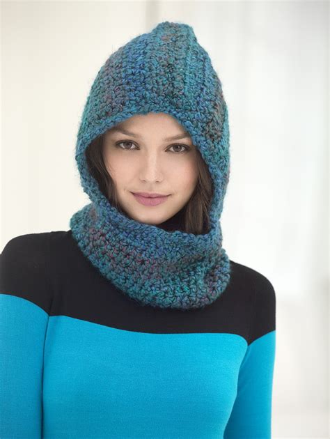 A Woman Wearing A Blue Hat And Scarf