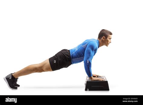 Muscular Man Exercising Push Ups On A Step Aerobic Platform Isolated On