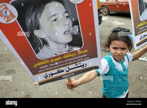 A Palestinian Girl Holds Posters Of Us Peace Activist Rachel Corrie