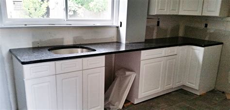 White cabinets set well with a broad selection of granite patterns. Steel Gray Granite Countertop Installation in Woodridge, NJ