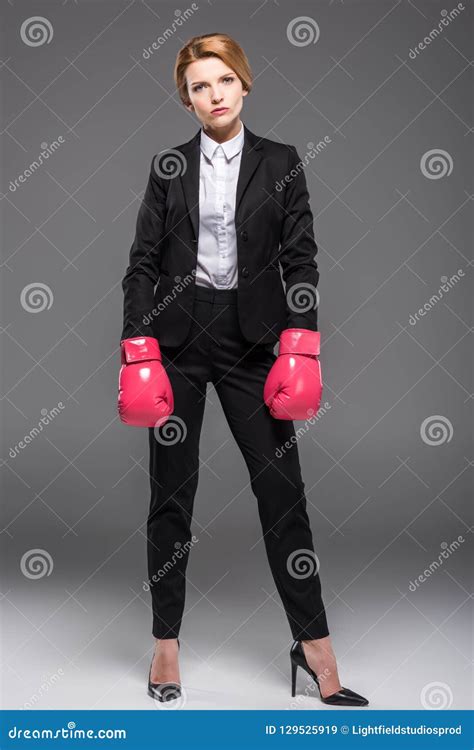 Serious Businesswoman Posing In Suit And Pink Boxing Gloves Stock Image