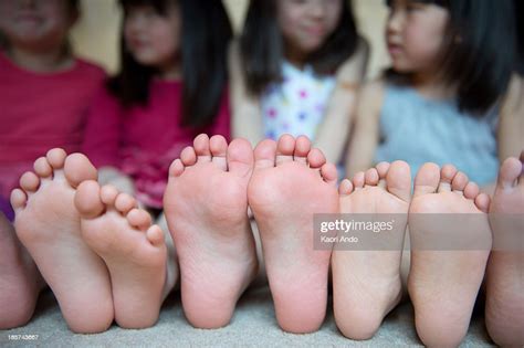 Girls Sitting Together With Barefeet In A Row Photo Getty Images