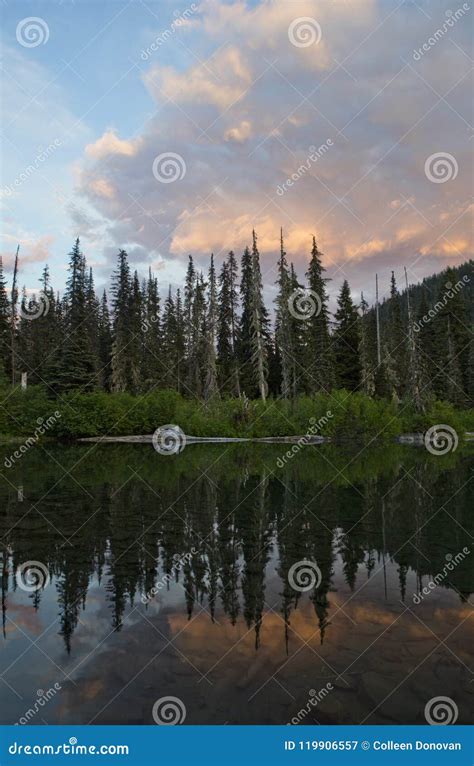 A Colorful Sunset Over An Alpine Lake And Forest In The Washington