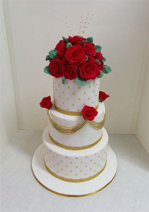 Three Tier White And Gold Wedding Cake With Red Fondant Roses White