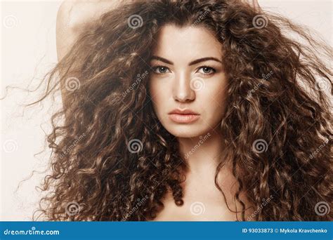 Close Up Of Beautiful Girl With Curly Hair Looking At Camera Over Pink Background Stock Image