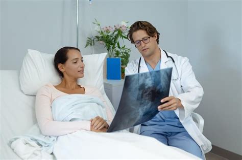 Premium Photo Male Doctor Interacting With Female Patient In The Ward