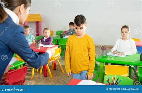 Teacher Complaining About Schoolboy In Elementary School Class Stock