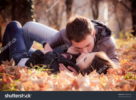 Kissing Young Couple In Love In The Autumn Park Stock Photo 99800483