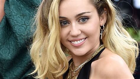 Miley Cyrus Stuns In A Sleek Black Bodycon Dress As She Sets Her Sights On 2023 Effortlessly
