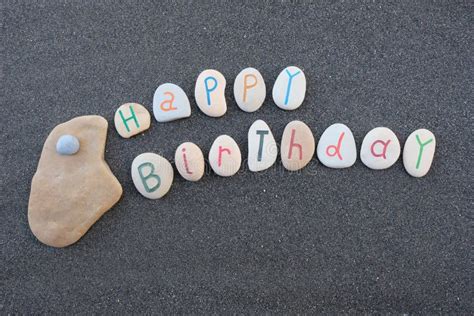 Happy Birthday With Carved And Painted Stone Letters Over Black