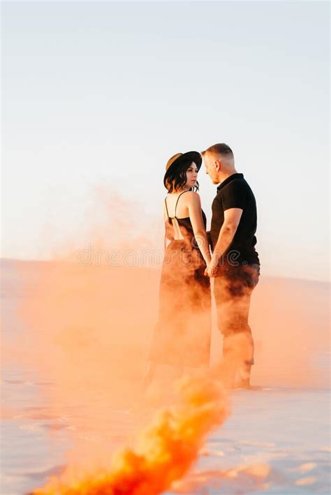 Guy And A Girl In Black Clothes Hug And Run On The White Sand Stock Image Image Of Sand Thick