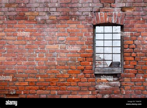 Window With Bars On The Background Of The Brick Wall Of
