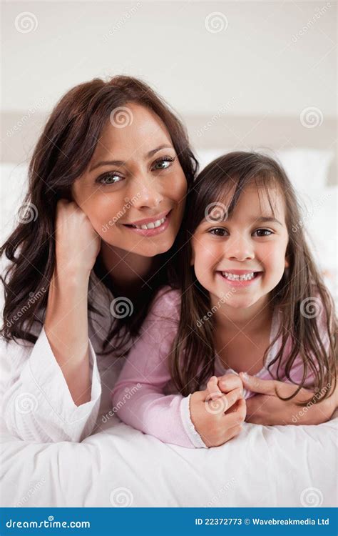 Portrait Of A Mother And Her Daughter Lying On A Bed Stock Image Image Of Cheerful Beautiful