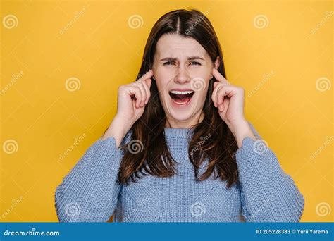 Portrait Of Crazy Frustrated Young Caucasian Woman Cover Ears With