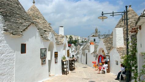 Puglia And Its Typical White Houses And Caves Taols