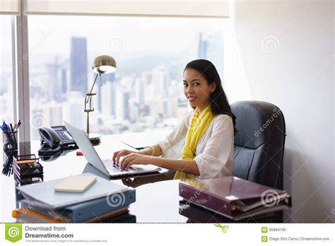 business woman assistant typing on pc and smiling at camera stock image image of happy