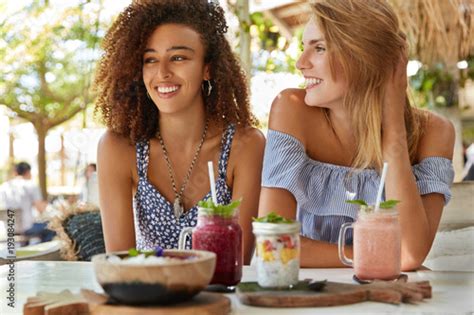 Pleased Female Lesbians Meet Together At Cafe Enjoy Tasty Desserts Have Recreation At Tropical