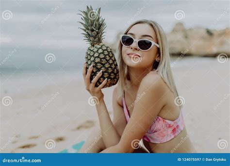 A Beautiful Girl Holding The Pineapple And Having Fun On The Ocean Beach Stock Image Image Of