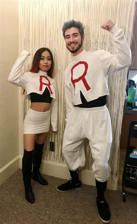 A Man And Woman Dressed Up In Costume Posing For A Photo With The Word