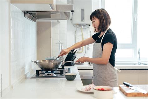 Young Woman Cooking In Kitchen By Stocksy Contributor Maahoo Stocksy