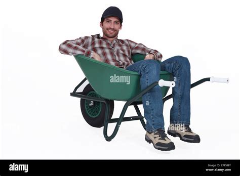 A Man Resting In A Wheelbarrow Stock Photo Alamy