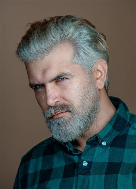 Mature Blonde Bearded Guy With Trendy Hairdo In Casual Shirt Smiling