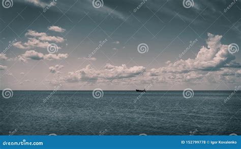 White Clouds Float In The Sky Over The Sea Coast Stock Photo Image Of