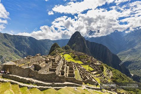 Mountain hiking goes hand in hand with popular tourist activities all over the world with it being one of the most fun activities to do for physically active. South America, Peru, Andes, Mountains landscape with Machu ...