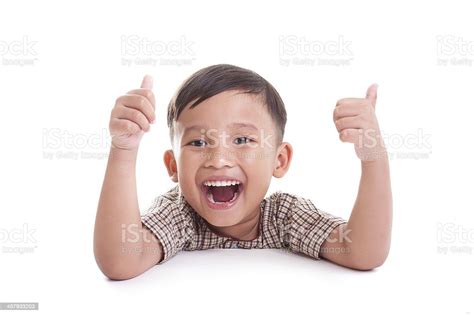 Portrait Of Cheerful Boy Showing Thumbs Up Gesture Stock Photo