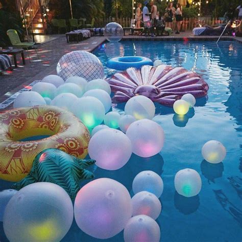 An Inflatable Pool Filled With Lots Of Balloons Floating On Top Of Its