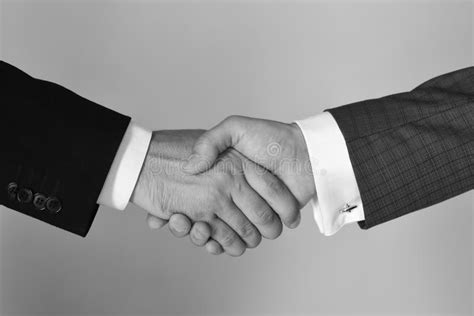 Men In Suits Or Businessmen Hold Hands In Handshake Stock Image