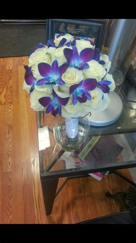 Bride is holding beautiful cascading purple orchid wedding bouquet. Azure Accents Bouquet: White Roses & Blue Dendrobium ...